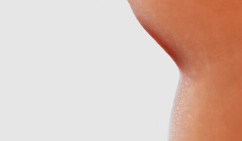 Abstract image featuring smooth, rounded shapes in varying shades of beige and peach, set against a white background.